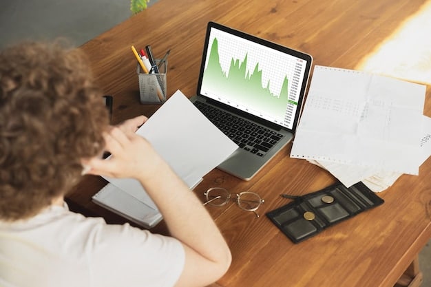 A person sitting at a desk, working at computer with chart showing income and investiment gains. Financial growth concept