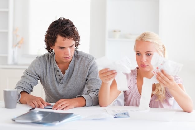 Two people reviewing financial documents together, illustrating the collaborative effort needed to manage finances during a divorce.