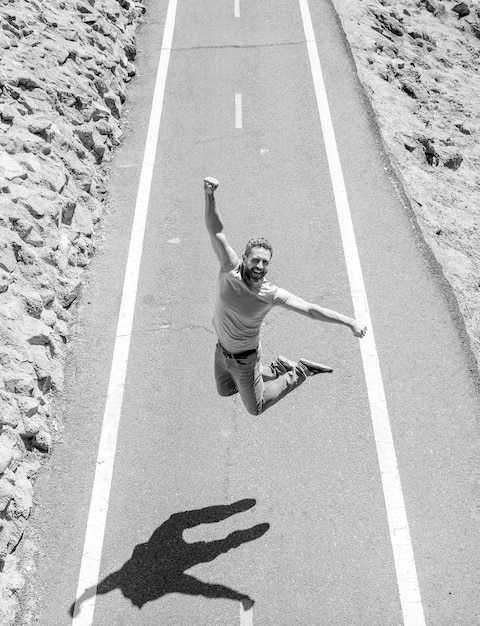 A person happily crossing the finish line of a race, symbolizing the feeling of relief and accomplishment after successfully refinancing their student loans. The background shows a financial chart trending upward.