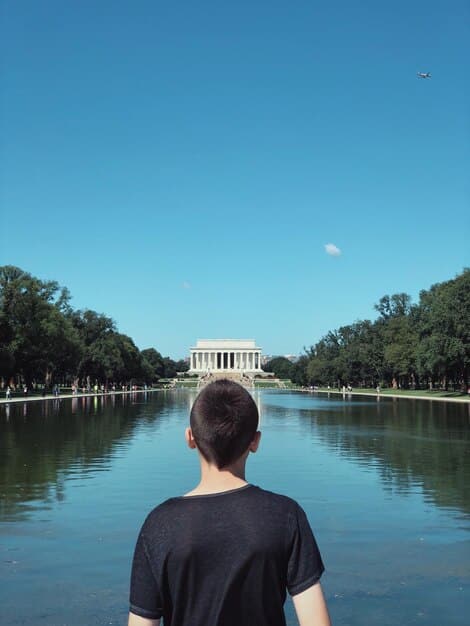 A split image showing the US Capitol Building on one side and a family looking at a tax form on the other, connected by a dotted line representing potential legislative changes affecting the Child Tax Credit.